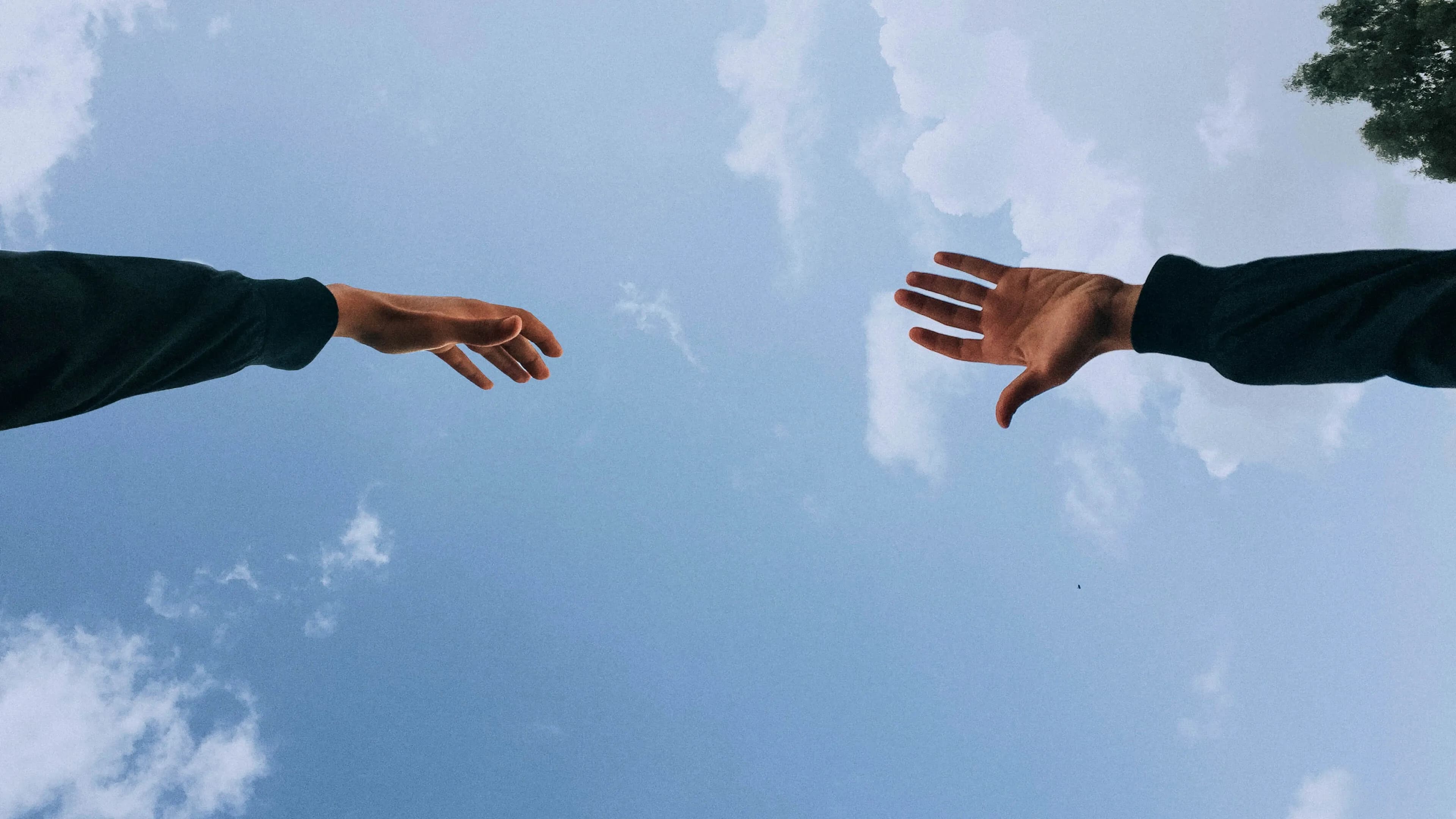 Hands reaching toward each other